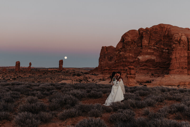 Wedding couple at Balanced Rock for their Arches National Park elopement