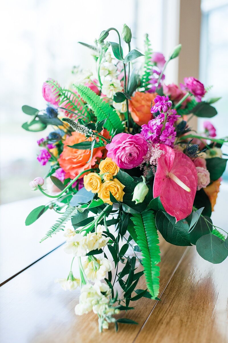 Bright pink, yellow, and green bridal bouquet with tropical flowers