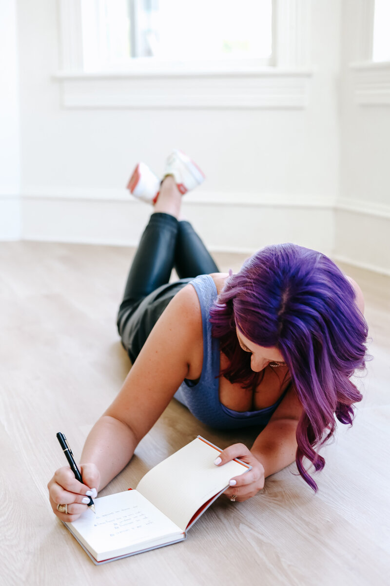 Photographer Resource Shop for Business Growth | Karinda K | Karinda writing on her notebook