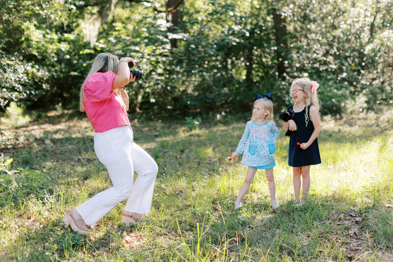 Woman takes photos of her kids in a park