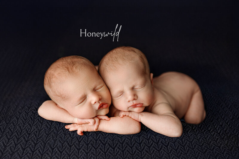 Newborn baby posed in the froggy position on a warm floral backdrop, wearing a delicate headband. Captured by Honeywild Photo, a Grand Rapids newborn photographer specializing in timeless and artistic portraits.