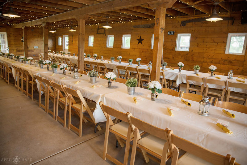 Long tables set up inside Green Farm Barn at Chatfield Farms Denver Botanic Gardens