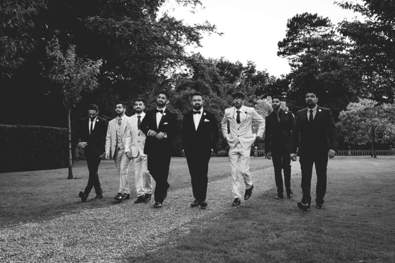 Groomsmen walk in line to wedding
