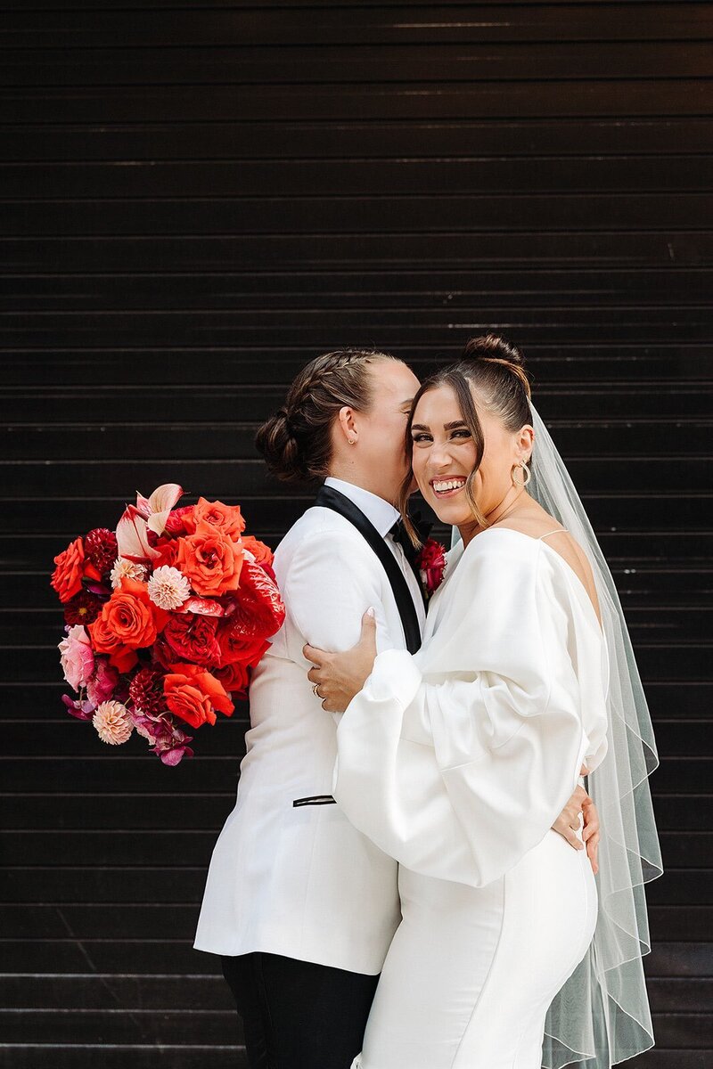 two-brides-with-modern-red-bouquet