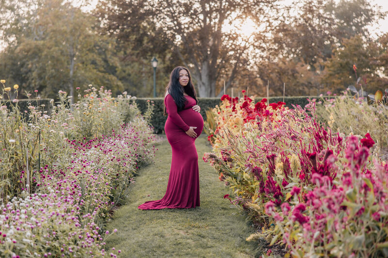 Pregnant woman in flower garden at Harkness Memorial State Park
