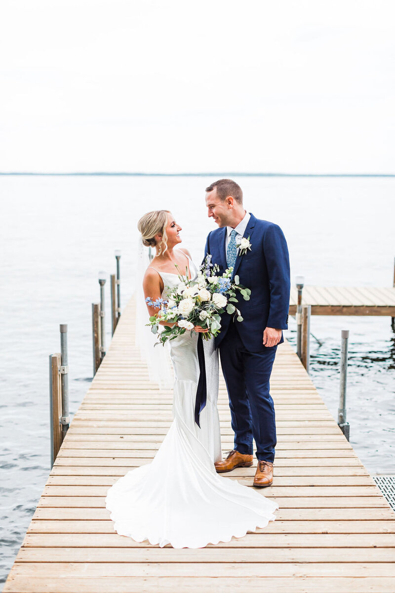 Couple standing out on the dock after their New England wedding