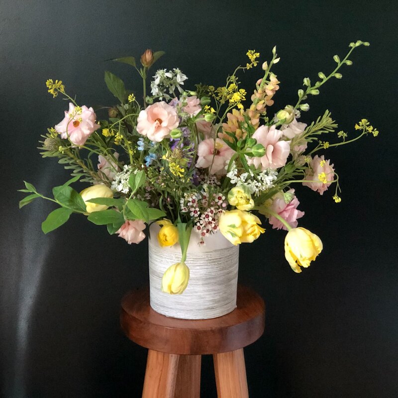 Beautiful floral arrangement featuring light pink and yellow florals