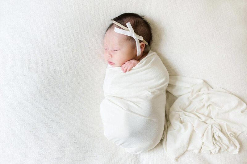 Dad holding newborn in studio