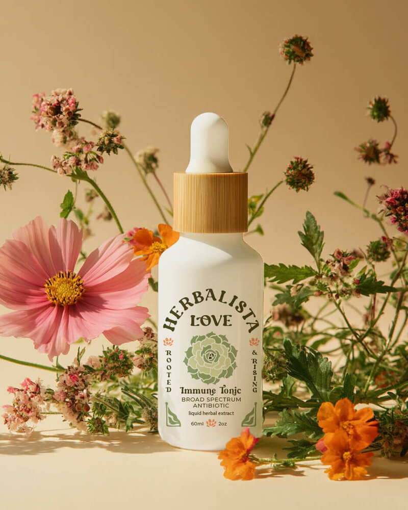 A bottle of Herbalista Love facial serum placed in a warm setting with colorful flowers. The glass dropper bottle features clean, minimalist packaging, aligning with the brand’s commitment to natural beauty and holistic skincare.