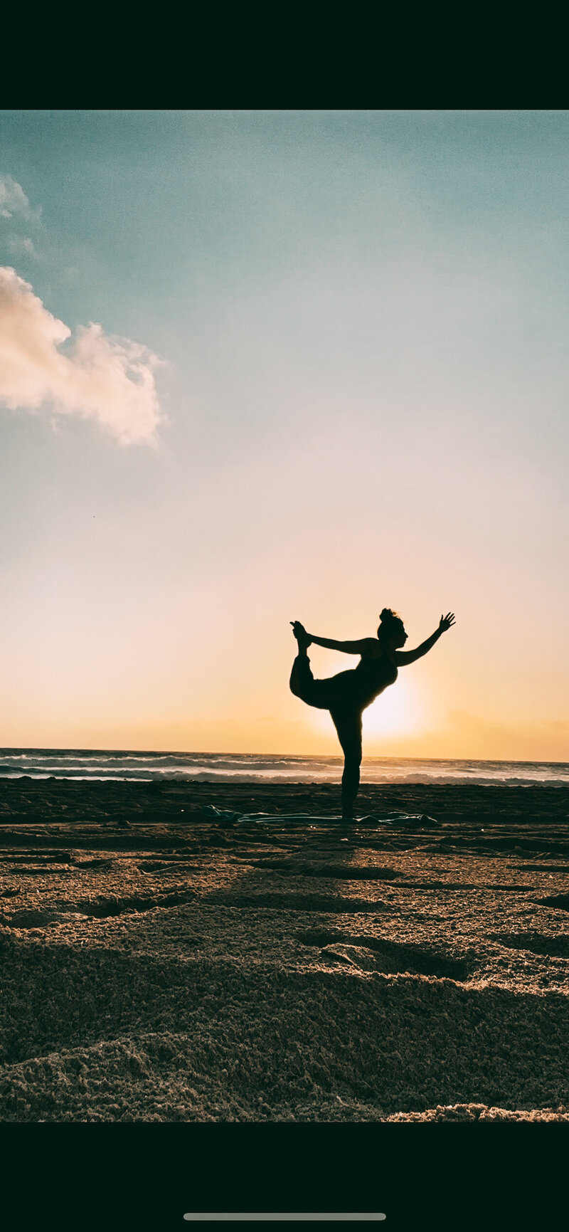 brin, owner of Golden Ray Studio, holding a yoga pose on the beach in St. Croix