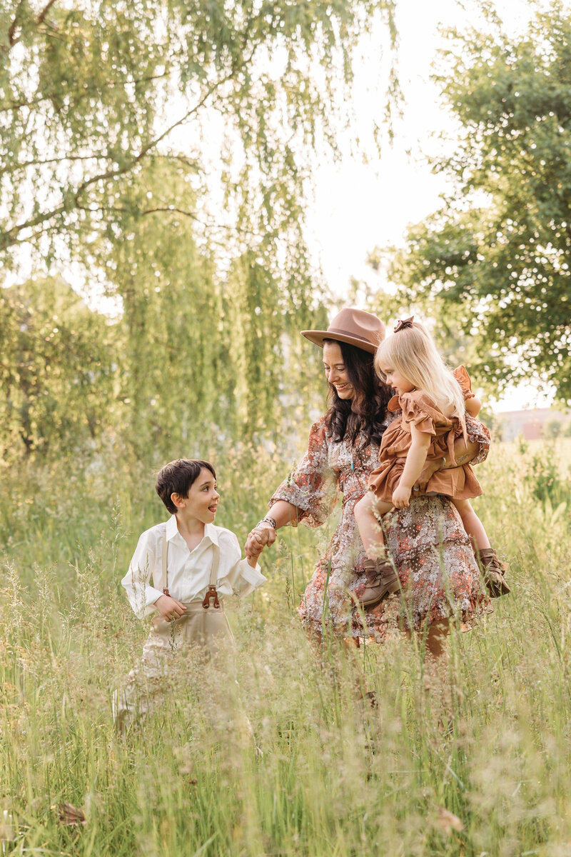 mom and kids walking a field family photoshoot