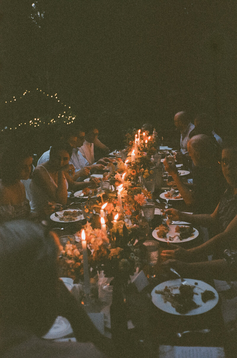 family around backyard wedding table on 35mm film