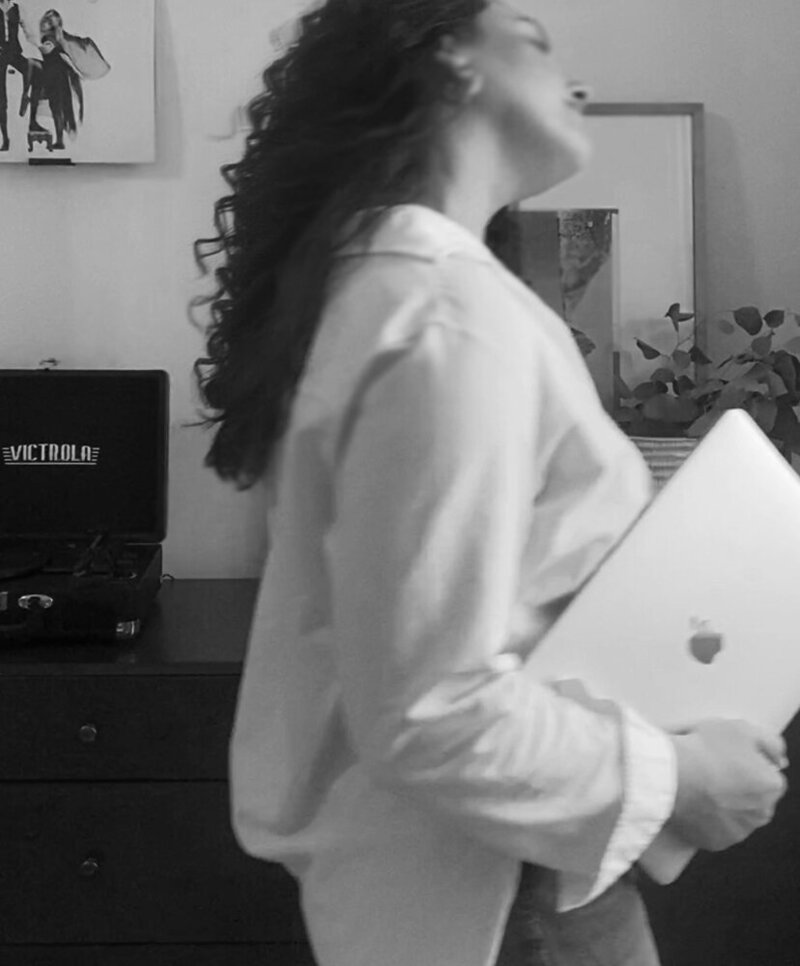 Hampton Roads female digital marketing consultant working on laptop in black and white