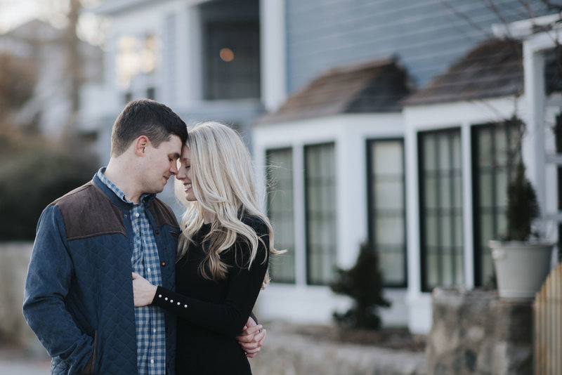 Couple in front of house engagement session