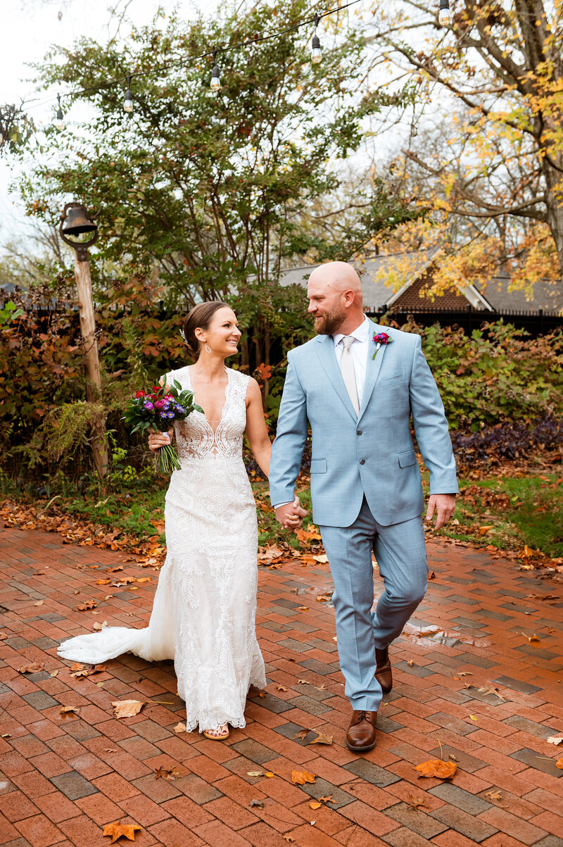 Bride and groom walking during their fall elopeemnt