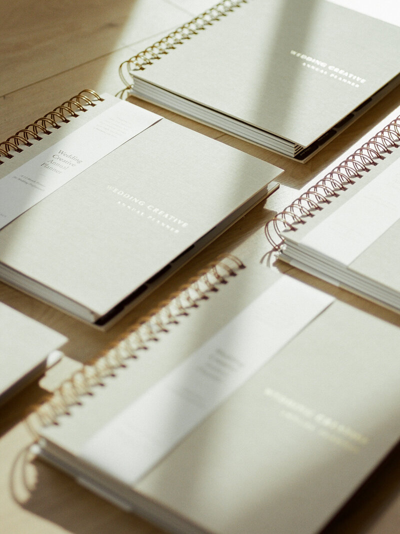 sunlit beige Wedding Creative Annual Planners, gold foil text, film product photographer in Michigan