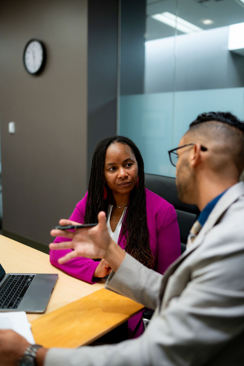 Central Ohio family law attorney advising a female client at a desk regarding domestic violence and civil protection order options