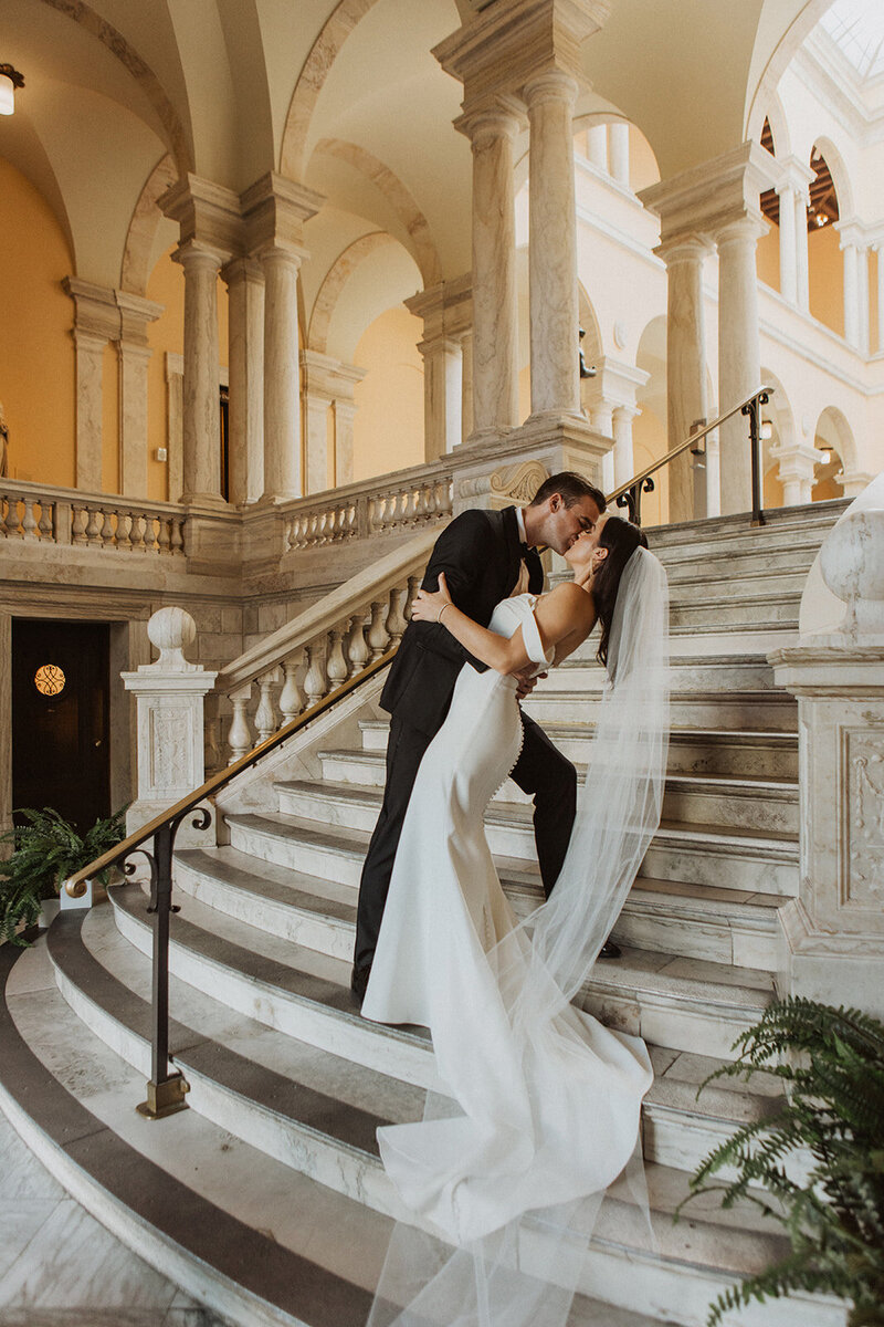 Couple Kisses on the Steps of a Washington DC Wedding Venue