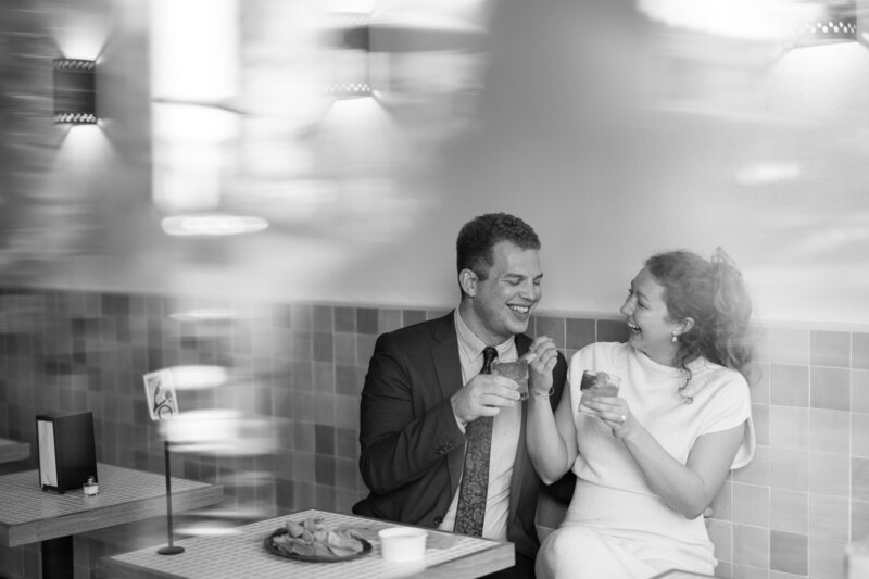 Couple sharing drinks at Alabama restaurant for engagement photos