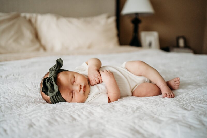 Newborn baby sleeping on bed