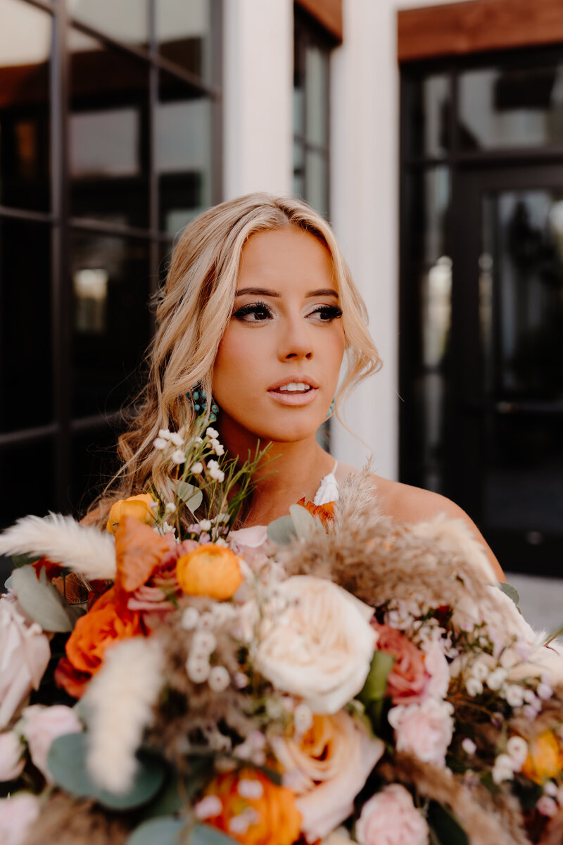 bride posing with flowers