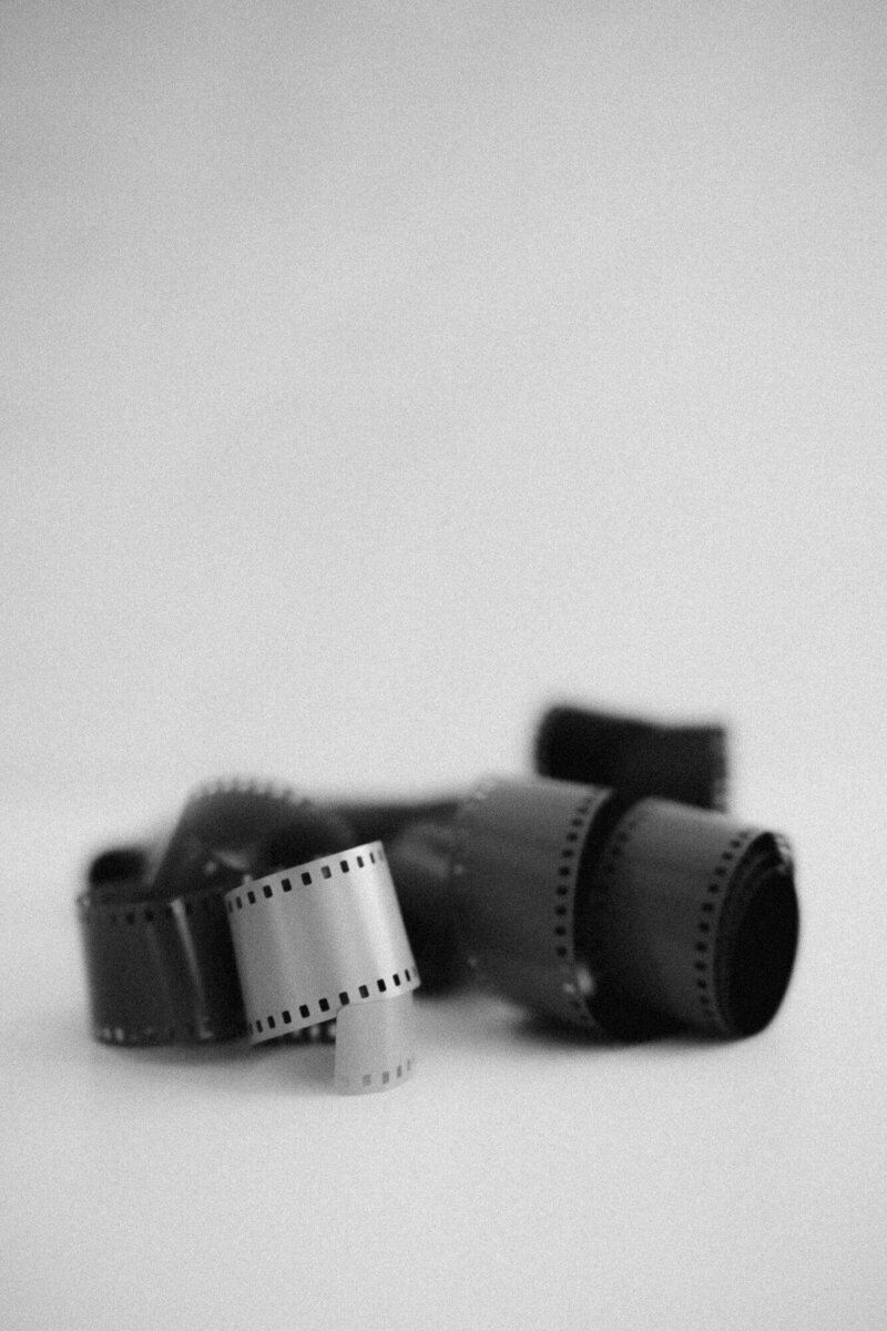 35mm black and white film rolls used in Phoenix boudoir photography sessions with vintage cameras, creating raw, nostalgic, and artistic portraits.
