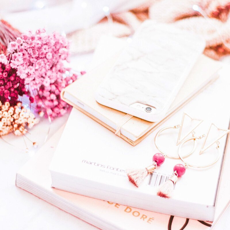 Stack of books, notebooks, phone to show luxury travel concierge services