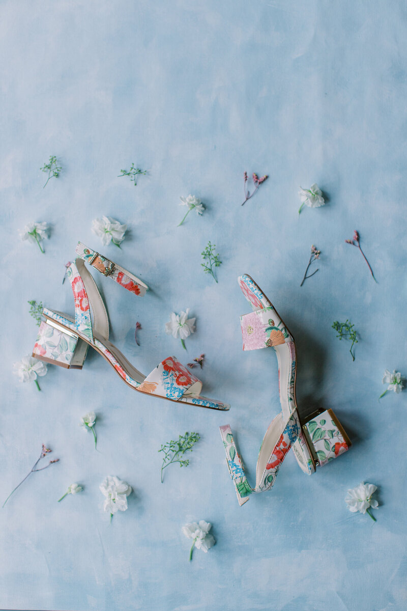 Wedding accessories including a champagne bottle, heart-shaped sunglasses, pearl earrings, and bridal shoes, perfect for a North Carolina wedding.
