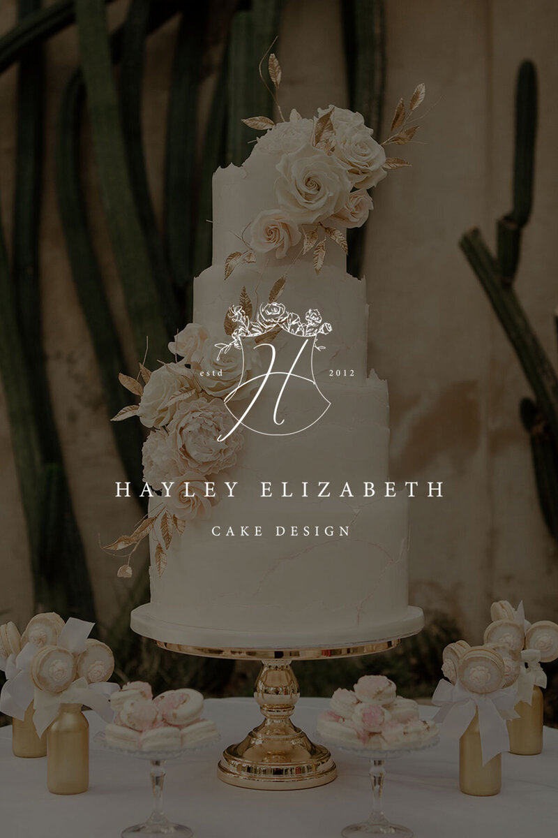 White brand emblem placed over a wedding cake photo with a rich green background