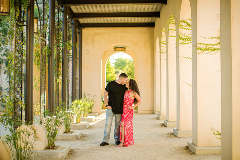 Couple laughing together in the Italian Garden during their engagement session at Longwood Gardens, radiating happiness.