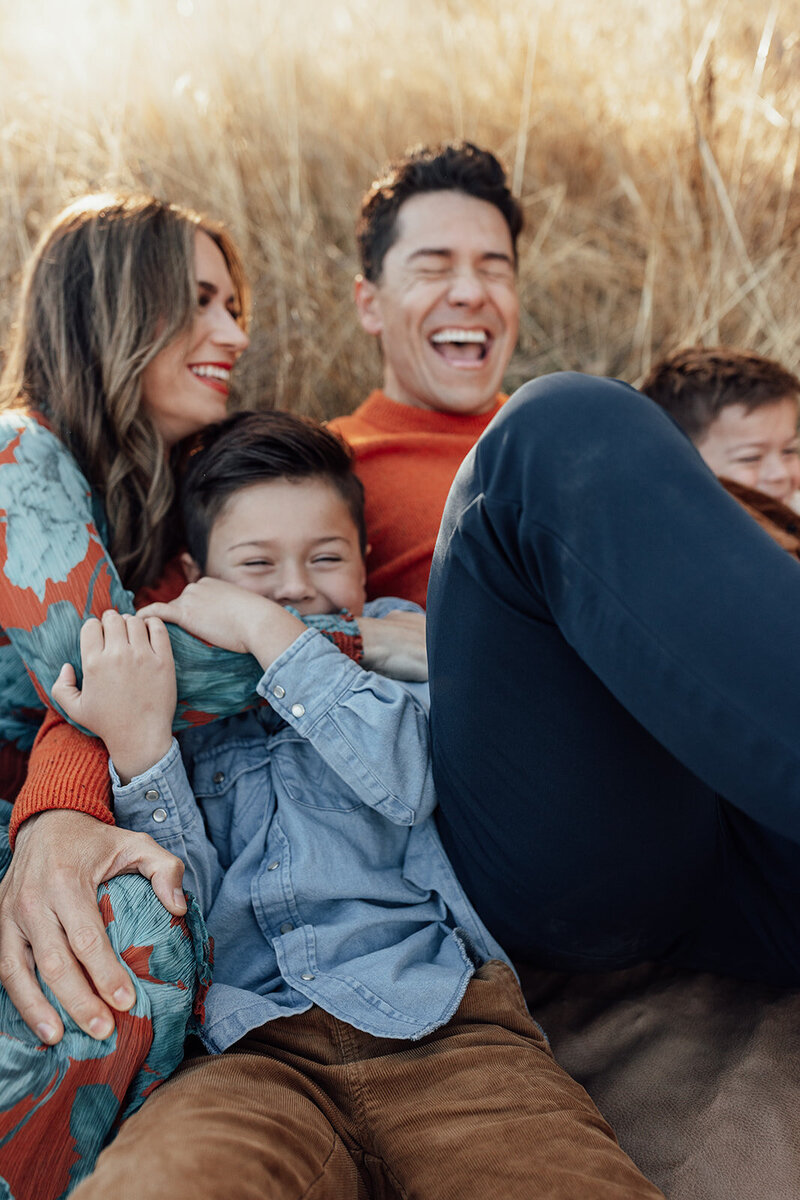 Candid family photo in a field at golden hour