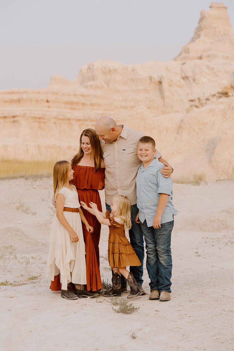 Family embracing and laughing in Badlands National park