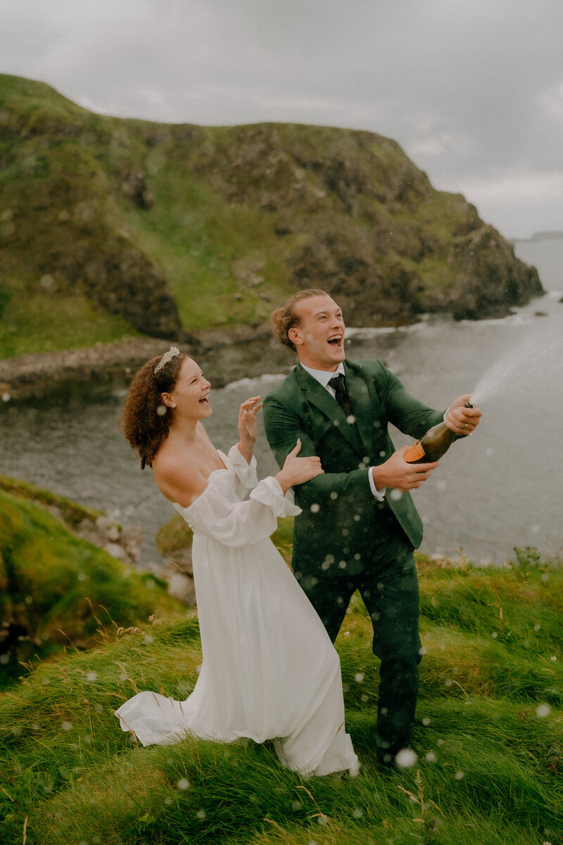 bride and groom running through sand dunes