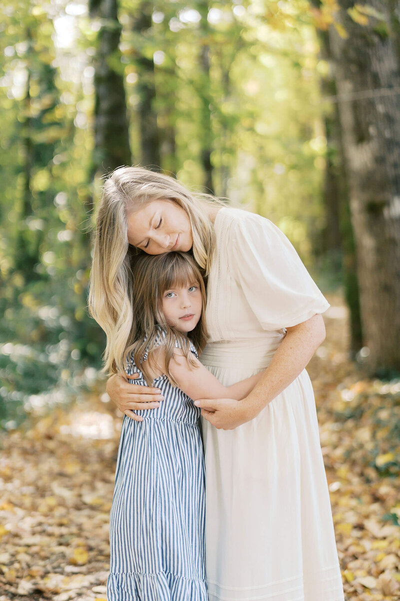mother and daughter hug, in an example of what to wear for fall family photography