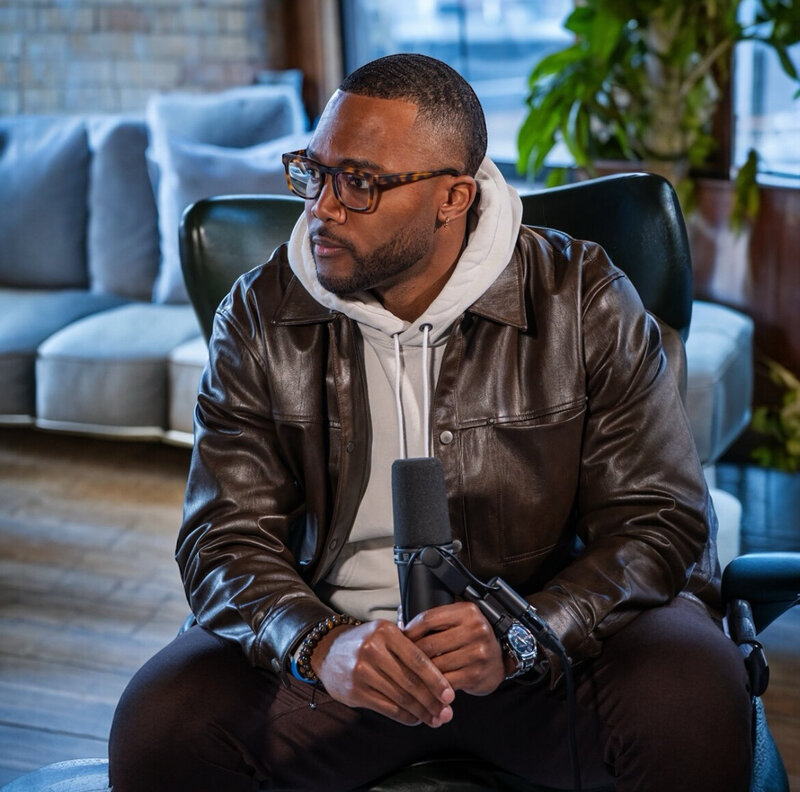 Dior Johnson interviewing a guest on the Perfecting Progression podcast in studio