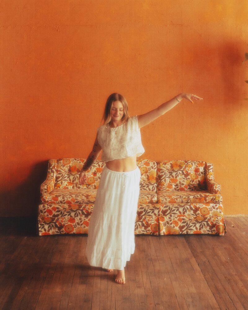 Artistic portrait of Brooke smiling warmly in her studio.