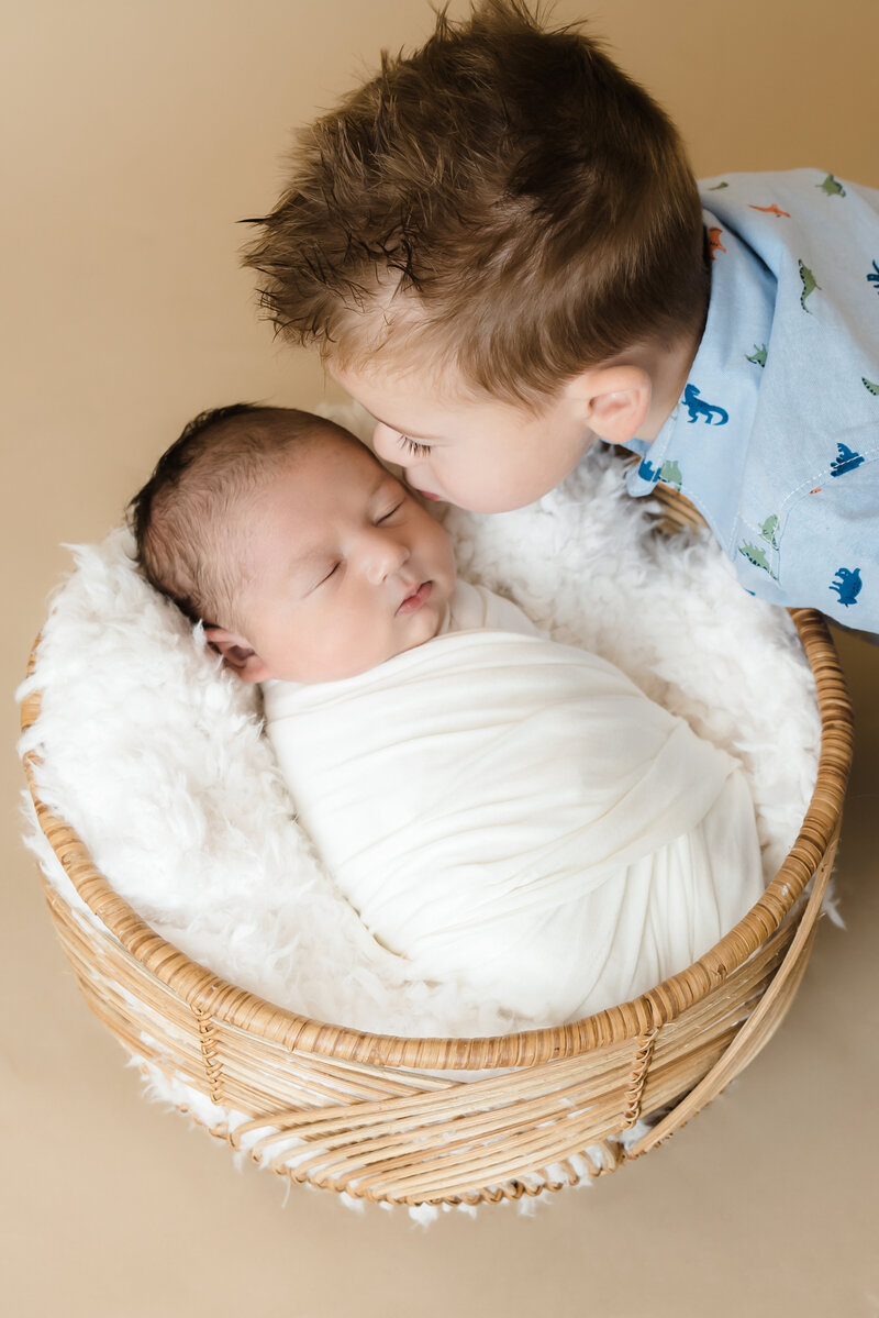 big brother kisses newborn brother on the cheek  | Family Photographer Pittsburgh