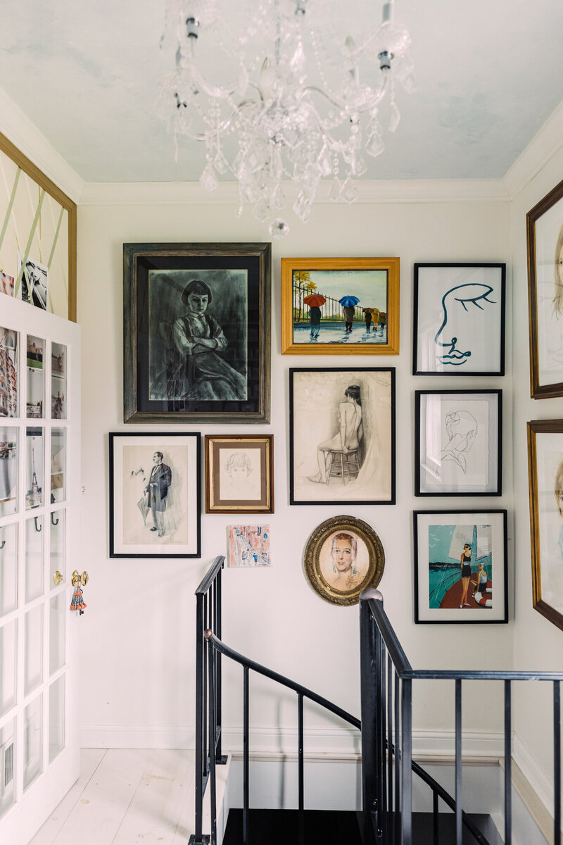 Gallery wall by spiral staircase – Wheaton IL interior photography
