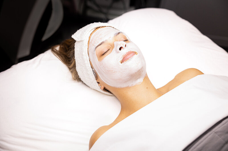 a woman relaxing during a facial treatment