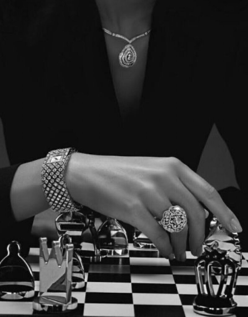 woman wearing jewelry playing chess