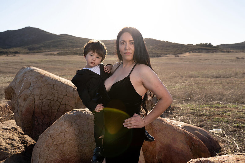 mom holding son in photo in the desert