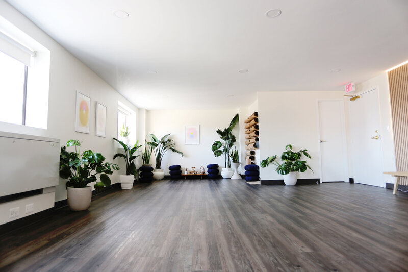 Lobby view at The Hive with plants, mirrors, and modern seating