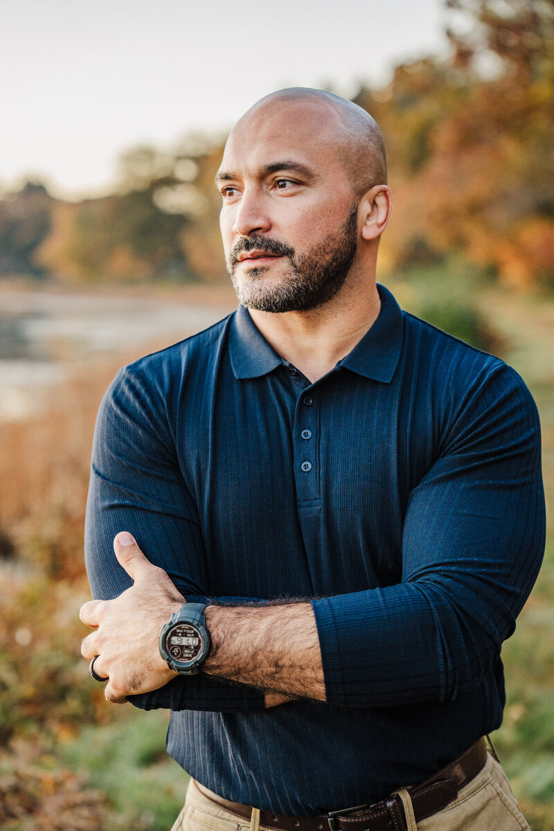 man crosses arms and looks to the side for his boston portrait