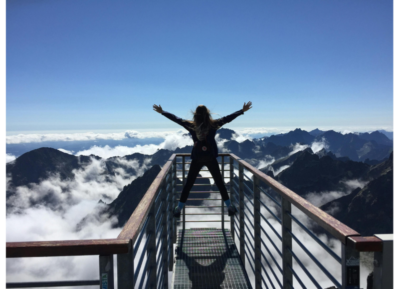 Woman over a mountain bridge, jumping