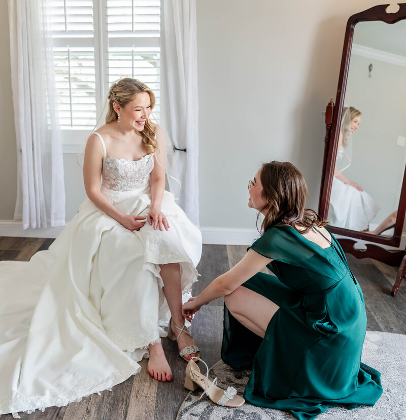 Bride receiving touches before walking down the aisle at Piazza Messina in Cottleville, MO, captured by Style & Grace Photography.
