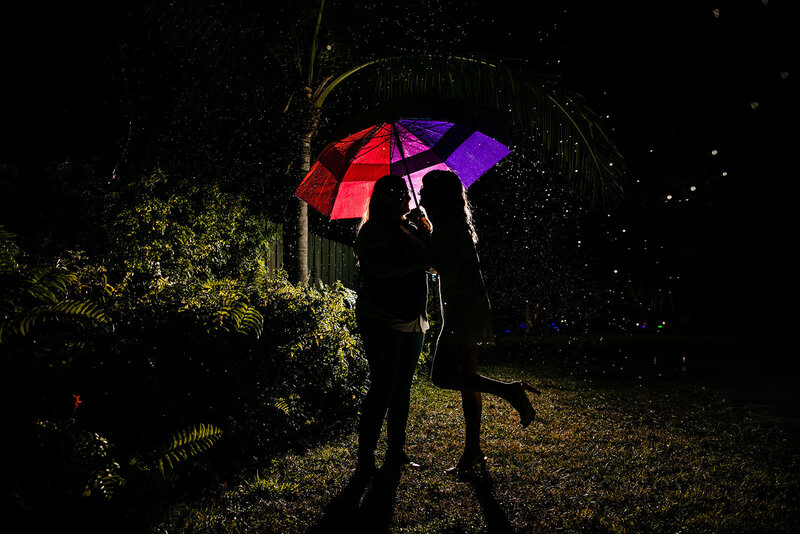 Night-Portrait-Engaged-Couple-Under-Rainbow-Umbrella