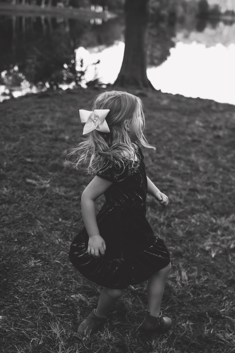 a little girl twirls during a family session in gainesville florida