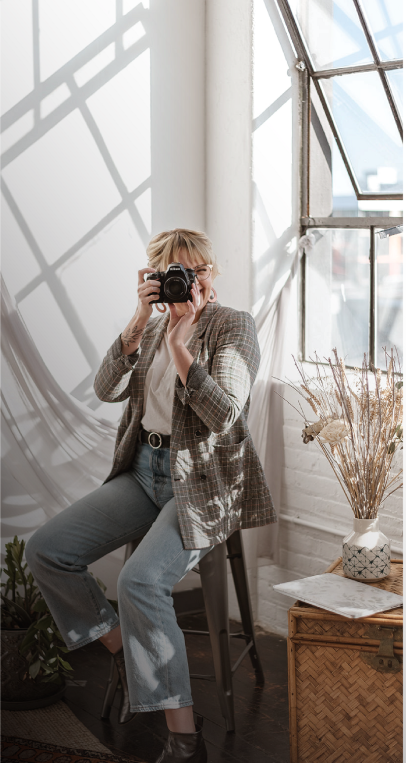 Philadelphia Photographer Heather McBride holding a camera.