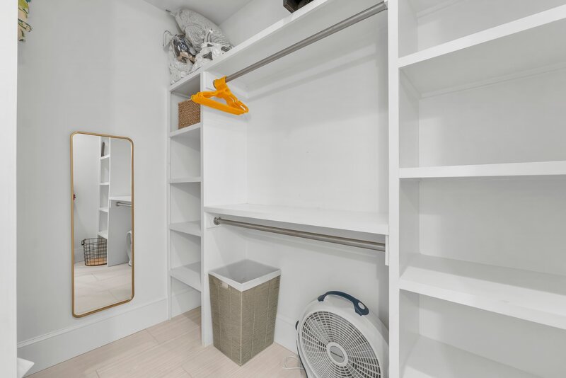 Large walk-in closet with built-in shelves and hanging space at Tangerine Dream near Panama City Beach and 30A.
