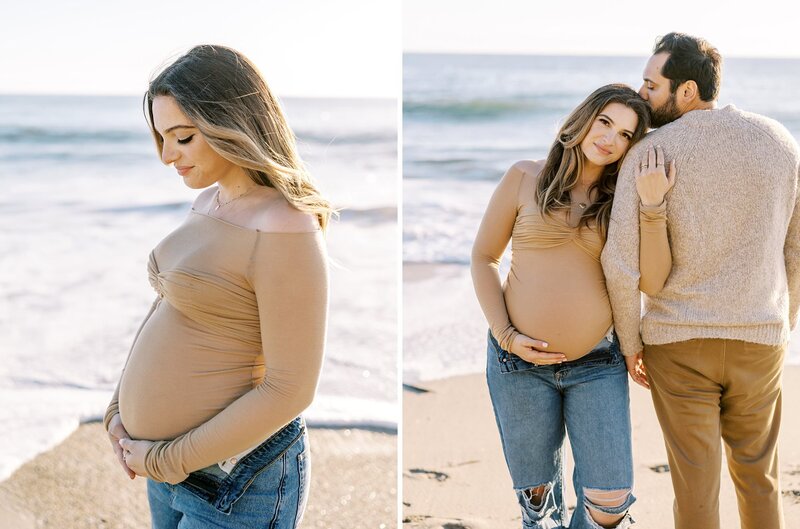 A pretty mom in a tan sweater and blue jeans on the beach during her maternity session